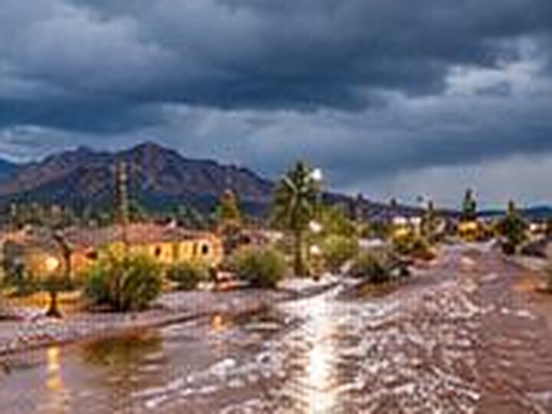 Desert neighborhood street flooded after a monsoon storm