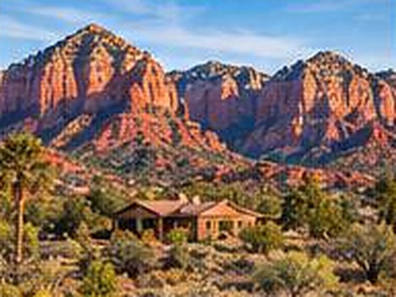 Red rock formations near Sedona with a home in the valley